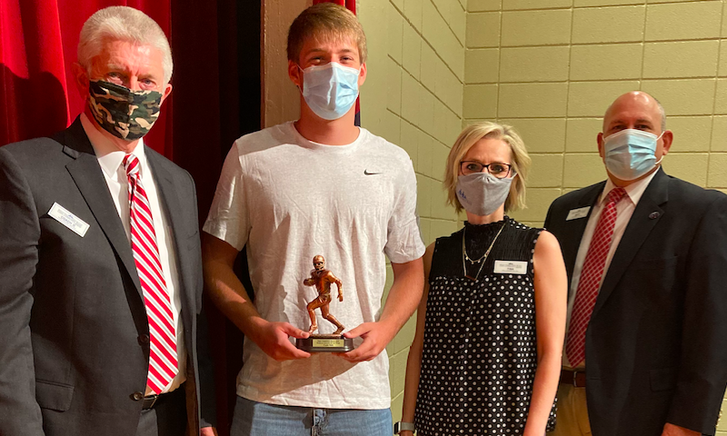 First Community Bank representatives David Daniel, Tina Novak and Matt House present Harding Academy QB Caden Sipe the FCB Scholar Athlete of the Week award